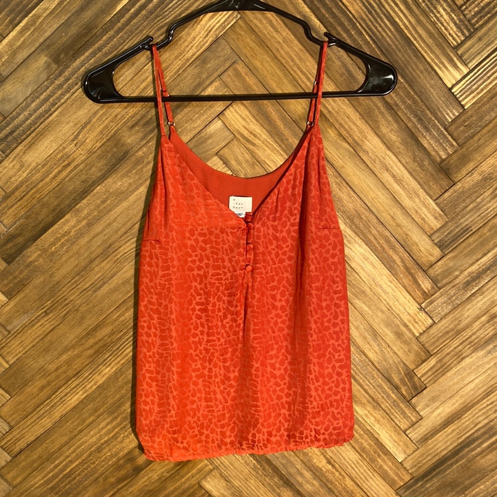 Women’s size: small red cheetah print blouse.
